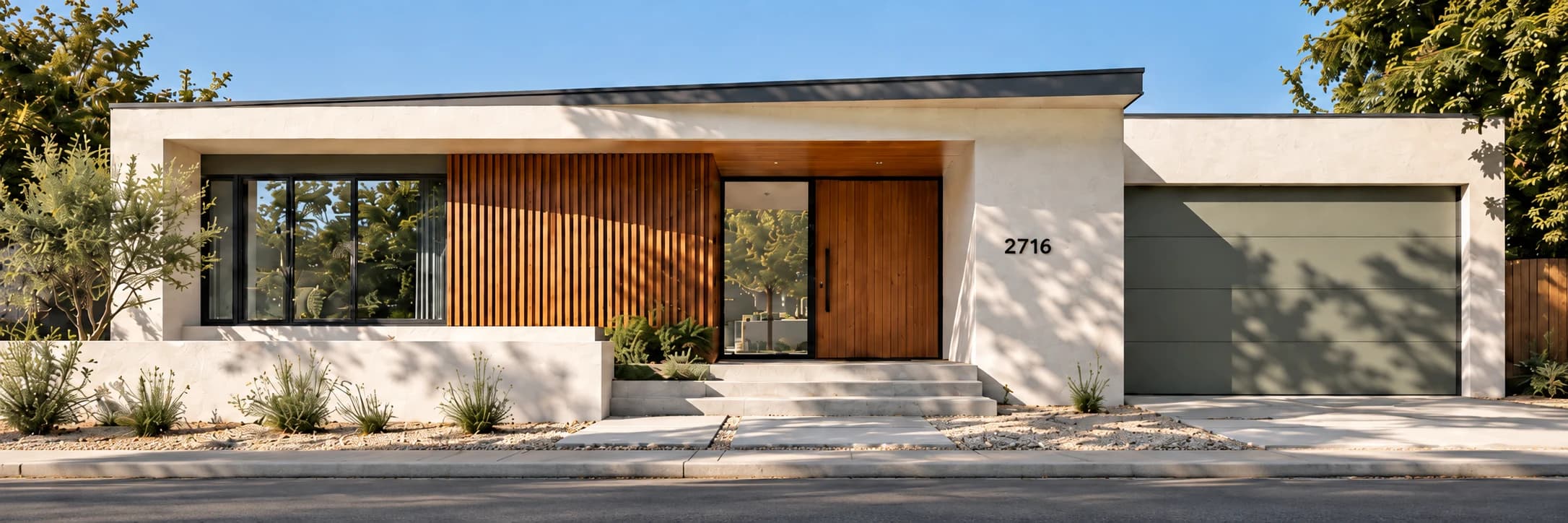 A sunlit home with white walls and a natural wood entrance.